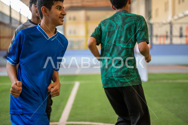 A close-up of Saudi Gulf Arab students performing warm-up exercises, running in the school playground, exercising, physical education class, education in the Kingdom of Saudi Arabia
