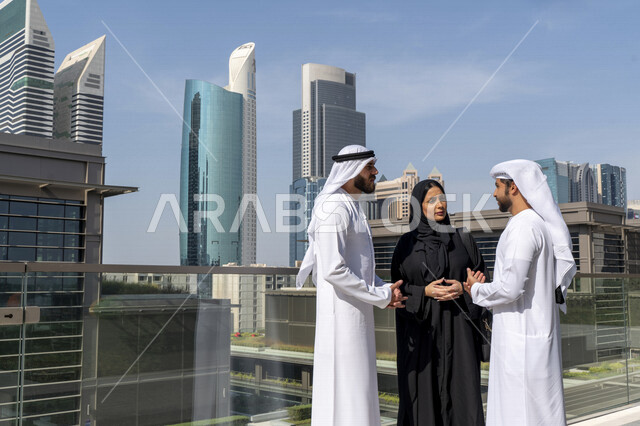 Emirati Gulf Arabs working outside the company's headquarters, touring abroad, general talks, work discussions, co-workers, business meeting in the open air, the end of work, exit of employees, Emirati professions and jobs, Gulf companies and offices in t