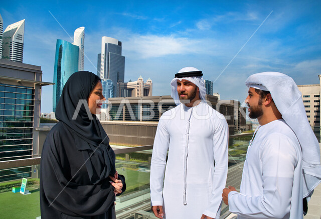 Emirati Gulf Arabs working outside the company's headquarters, touring abroad, general talks, work discussions, co-workers, business meeting in the open air, the end of work, exit of employees, Emirati professions and jobs, Gulf companies and offices in t
