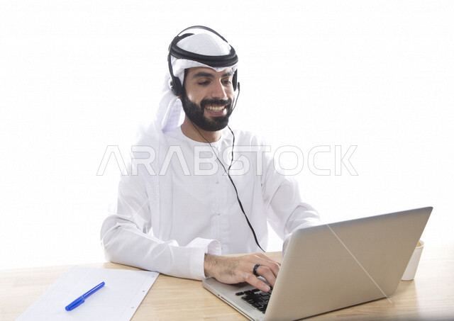 بورتريه موظف عربي خليجي اماراتي يعمل في خدمة العملاء ويرتدي سماعة الاتصال، استعلامات واستفسارات، الاجابه على اسئلة العملاء، اجراء اتصال فيديو من خلال الحاسوب ، متابعة وتطوير العمل , خلفية بيضاء .