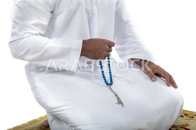 Portrait of an Arab Emirati Gulf Muslim man, sitting on the prayer rug ...