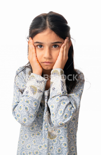 Sadness, frustration and the desire to cry, facial and hand gestures indicating a feeling of disappointment, a close-up portrait of an Arab Emirati girl placing her hands on her cheeks, a Saudi girl wearing a Gulf dress regretting something, loss and fail