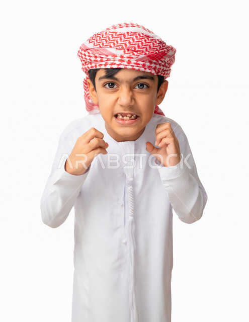 اشارات تدل على المشاكسه والعناد والتصرف بحركات غير لائقة، بورتريه مقرب لفتى عربي اماراتي خليجي يرتدي العمامة والكندورة الاماراتية ويرفع يديه للهجوم على شيء ما بشراسة ، سوء الخلق والتربيه ، خلفية بيضاء