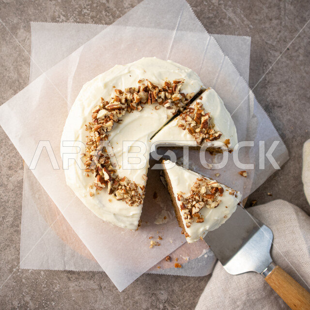 قالب الكيك الهش واللذيذ، تزيين الكيك بالمكسرات الطازجة، كيكة هشة غنية بالكريمة البيضاء، كرم الضيافة، مخبوزات طازجة 