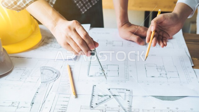 A group of engineers in a business meeting, drawing the structural plan on paper, agreeing on an architectural plan, attractive modern designs, luxurious and beautiful designs, modern engineering architectural design