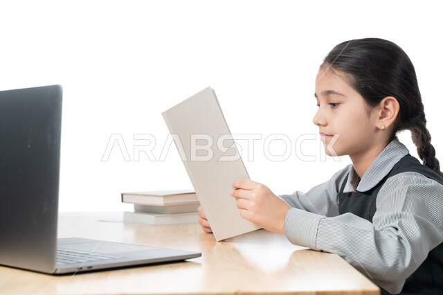 Following classes and doing homework online, a close-up portrait of a Gulf Arab Emirati student wearing a school uniform and studying at home, studying and studying remotely, the concept of e-learning, a diligent Saudi student reviewing her lessons from b