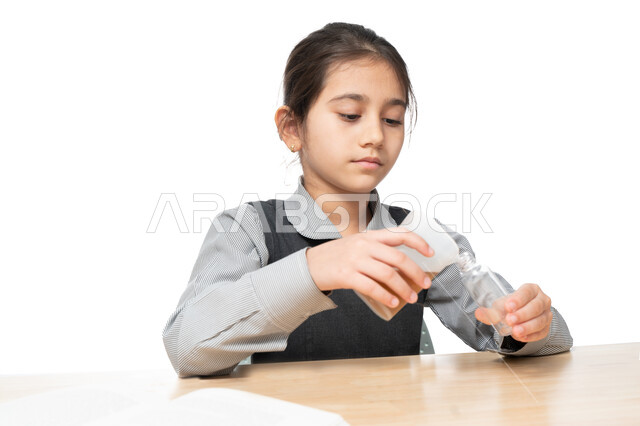 Acquisition of knowledge through modern practical experiments, a close-up portrait of an Arab Gulf Emirati student in an advanced educational environment, a Saudi student conducting a scientific experiment in the school laboratory, creativity, educational