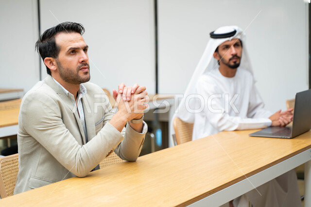 Close-up of Arab Emirati Gulf students in the lecture hall at the university, interaction and participation, taking notes, listening to the lecture, workshops, training courses, lessons and lectures, quality of education, academic universities in the Emir