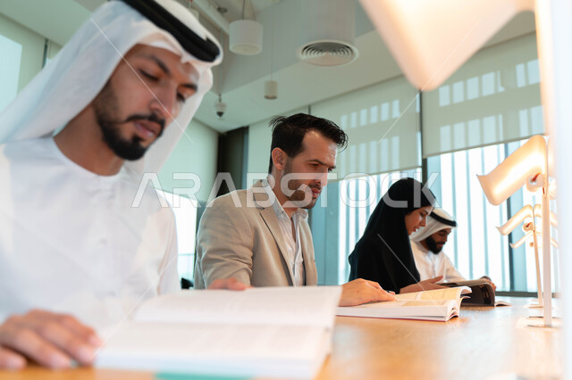 Close-up of Arab Emirati Gulf students in the lecture hall at the university, interaction and participation, taking notes, listening to the lecture, workshops, training courses, lessons and lectures, quality of education, academic universities in the Emir