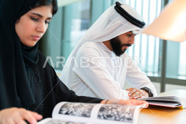 Close-up of Arab Emirati Gulf students in the lecture hall at the university, interaction and participation, taking notes, listening to the lecture, workshops, training courses, lessons and lectures, quality of education, academic universities in the Emir