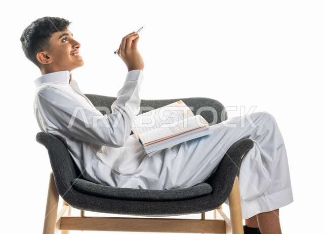 بورتريه لولد عربي سعودي خليجي، يجلس على كرسي، تعابير تدل على التفكير، تأدية الواجبات المدرسية، مراجعة الدروس، الإستعداد للعام الدراسي الجديد، التعليم الدراسي في السعودية ، العودة إلى المدارس، المذاكرة للإختبارات المدرسية، خلفية بيضاء