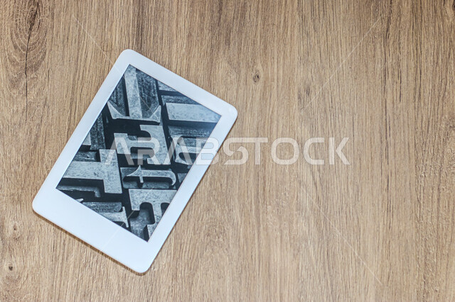 Tablet on a wooden background, modern e-reader, advanced modern devices, technology and technology, wooden background