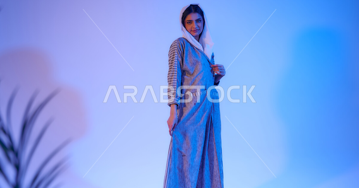 Portrait of a Saudi Arabian Gulf woman wearing an elegant colorful ...