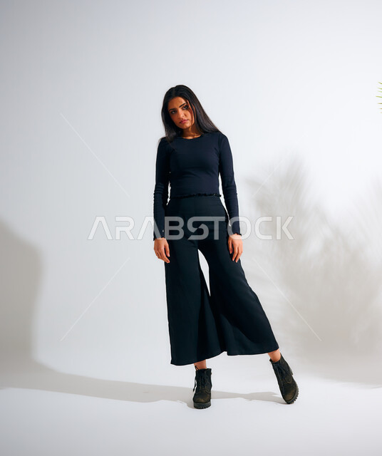 Portrait of a Saudi Arabian Gulf woman wearing casual clothes, model, women's clothing with modern designs, fashion and elegance, new Gulf models, fashion and accessories, follow fashion and fashion, winter fashion, white background, full-length body imag
