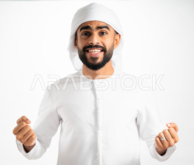 Competition, challenge and encouragement, joy and happiness with victory and victory, a portrait of an Arab Emirati man wearing a turban and an Emirati kandura, two hand gestures indicating enthusiasm and passion, success, strength and achieving goals, a 