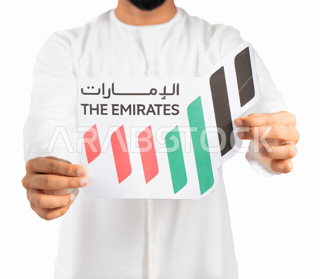 يوم توحيد الولايات وإستقلال الإمارات، بورتريه مقرب لرجل إماراتي عربي خليجي يرتدي الكندورة والعمامة الإماراتية ويحمل بيده شعار على شكل خريطة الإمارات العربية المتحدة ملون بألوان العلم الإماراتي، إحياء ذكرى العيد الوطني الإماراتي، خلفية بيضاء
