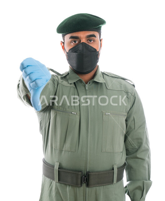 إيماءات إبهام لأسفل تدل على الرفض والإستياء، بورتريه لمحقق أدلة جنائية عربي خليجي إماراتي يرتدي الكمامة الواقية والقفازات وبدلة الأمن الخضراء، مكافحة الإشاعات الكاذبة وكشف الجرائم، عدم الرضى عن التحقيقات، خلفية بيضاء
