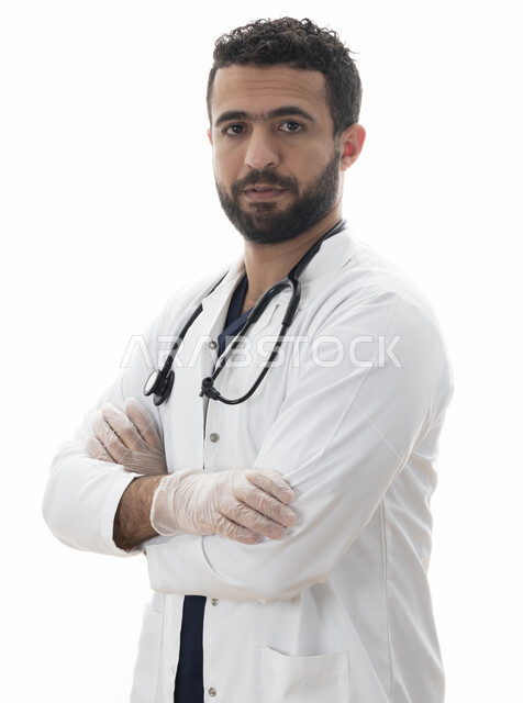 Preparedness to efficiently provide services to patients, the concept of medicine and health care, a close-up portrait of a Saudi doctor standing with crossed hand gestures, adhering to the doctor’s instructions and recommendations, an Emirati Arab Gulf y
