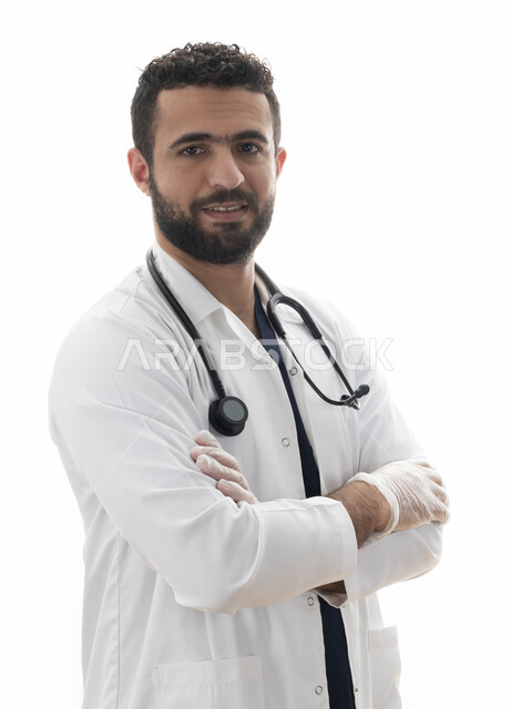 مفهوم الطب والرعاية الصحية، الاستعداد لتقديم الخدمات للمرضى بكل كفاءه ،الوقوف بأيدي متقاطعه، بورتريه مقرب لطبيب سعودي يقوم بالالتزام بتعليمات وتوصيات وزارة الصحة، شاب عربي اماراتي خليجي يرتدي المعطف الطبي وسماعه الطبيب، مهن ووظائف طبية في القطاع الصحي
