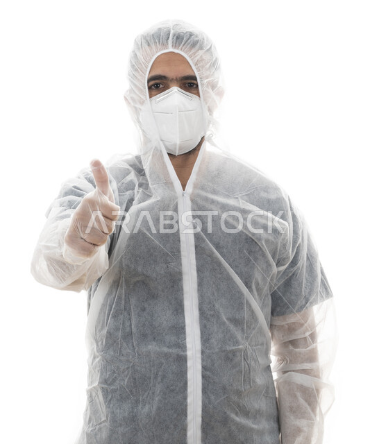 Hand gestures indicating the sign of quality in maintaining safety, a close portrait of a Saudi doctor wearing protective clothing to combat the Corona virus, an Emirati Arab Gulf youth pointing with his finger on the correctness of following the recommen