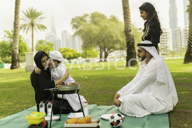 الاهتمام والاعتناء بالأطفال، رحلة في أجواء ربيعيه في الخارج, مفهوم الامومة والتربية بالعطف و الحنان، أجواء عائلية مليئة بالحب، صورة مقربة لعائلة عربية اماراتية خليجية في إحدى المنتزهات, عائلة سعودية تقضي أوقات ممتعه في الحديقة، لمة عائلية سعيدة