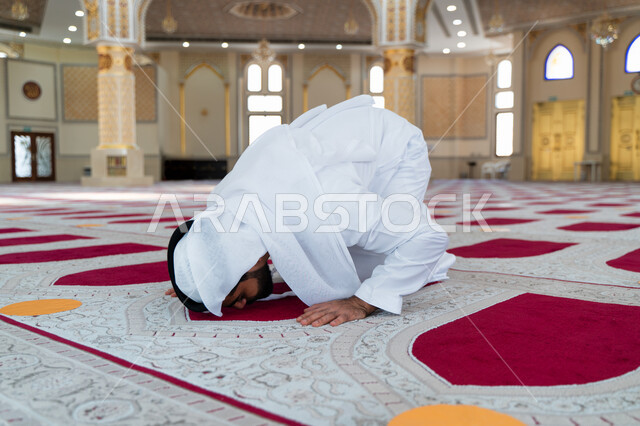 رجل عربي خليجي إماراتي في أحد المساجد العربية ، أداء فريضة الصلاة ، السجود في الصلاة ، العبادة والتقرب الى الله ، أماكن إسلامية مقدسة ، مفهوم أركان الإسلام ، إسلاميات وعبادة