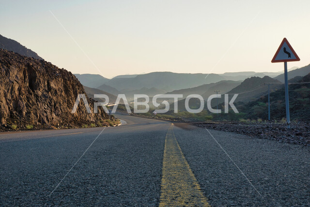 Close-up of an asphalt road in the middle of the mountains, rocky mountains, highway, stunning scenery, mountains and highlands