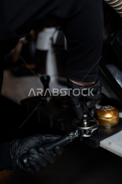 Close-up of a man preparing coffee, coffee machine, using the lever of the espresso machine, preparing an espresso cup, making delicious coffee, hot drinks