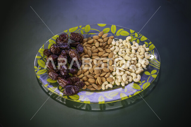 طبق من المكسرات المالحة مصورة على سطح داكن ، موالح ، مكسرات ، وجبات خفيفة صحية