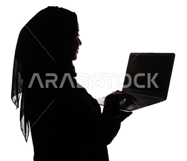 Portrait, silhouette of a Saudi Arabian Gulf woman, using a laptop, surfing the Internet, using modern technology devices, working remotely, e-marketing, professions and jobs, businesswoman, white background
