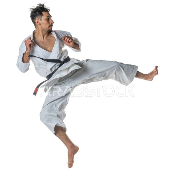 Application of kata movements, portrait of a Saudi Arabian Gulf man practicing Japanese karate, white karate uniform with black belt, training in special combat movements, martial arts, full-length body image, white background