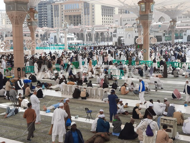 تجمع المسلمون في المجمع الخارجي للمسجد النبوي في المدينة المنورة بالمملكة العربية السعودية، ساحة المسجد النبوي الشريف، الحرم النبوي الشريف، أماكن إسلامية مقدسة، المظلات الالكترونية، معالم دينية إسلامية
