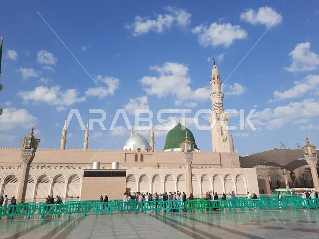 Muslims gathered in the outer complex of the Prophet’s Mosque in Madinah, Kingdom of Saudi Arabia, the square of the Prophet’s Mosque, the Prophet’s Noble Sanctuary, Islamic holy places, the Green Dome, Islamic religious landmarks