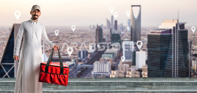 رجل عربي خليجي سعودي يحمل حقيبة حمراء، عامل توصيل الطلبات، خدمات التوصيل السريع، طلبات الدليفري، خدمات التوصيل المنزلي، الطلب عبر الإنترنت، خدمات توصيل الطعام، طلبات الأونلاين، الابراج وناطحات السحاب، مدينة الرياض، خلفية ابراج الرياض