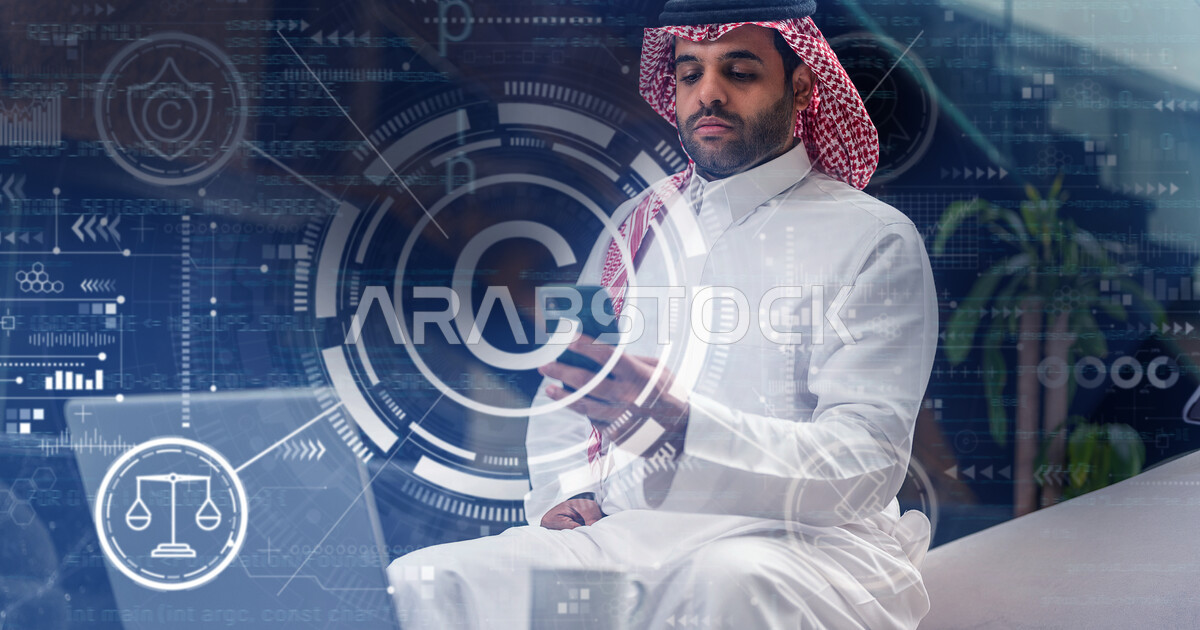 A Saudi Arabian Gulf man using a laptop to develop a computer network ...