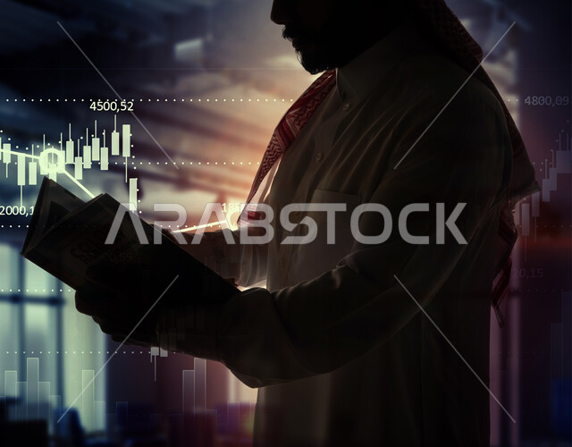 صورة مقربة لرجل عربي خليجي سعودي يمسك بيده كتاب، الرسم البياني، النمو الاقتصادي، التثقف في الادارة المالية، معرفة المعلومات المالية، صعود وهبوط مؤشر البورصة، خلفية الرسم البياني للسوق المالي