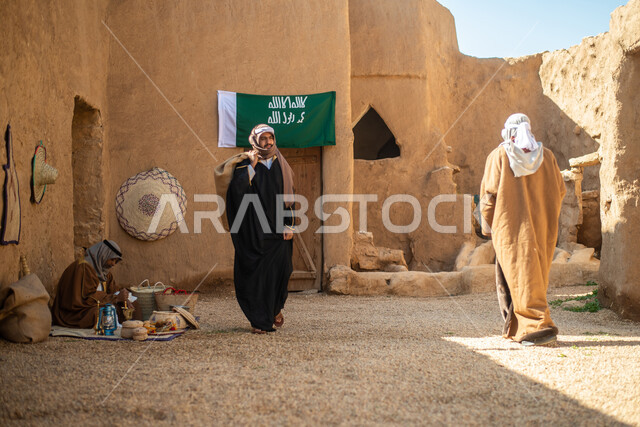 A group of people inside an old popular market, handicrafts and works, revival of Gulf folklore, popular handicrafts and professions, Saudi founding day, the founding of the Kingdom 1727 AD, Saudi folk costumes, old Saudi Arabia, old traditional mud house