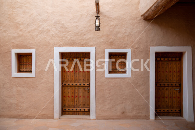 The old houses in Diriyah in Riyadh in the Kingdom of Saudi Arabia, the historical Al-Turaif neighborhood, wooden doors and windows, lanes and alleys of the Diriyah neighborhoods, the jewel of the kingdom, a heritage village, the ancient buildings in Diri