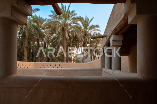 The old houses in Diriyah in Riyadh in the Kingdom of Saudi Arabia, the historical Al-Turaif neighborhood, green palm trees, the jewel of the kingdom, a heritage village, the ancient buildings in Diriyah, the historical landmarks of Saudi Arabia