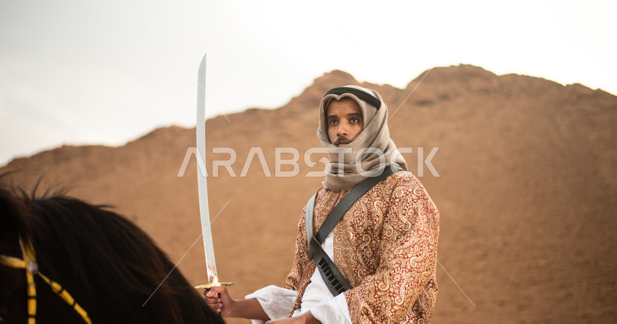 A Saudi Arab Gulf knight riding horses in the Saudi desert, the Saudi ...
