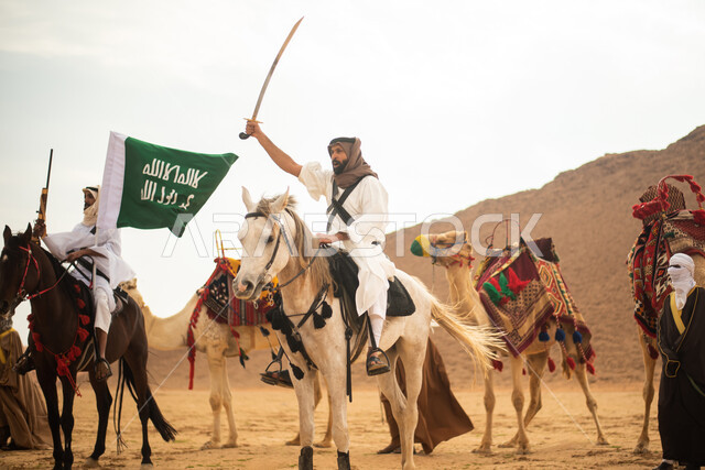 Saudi Gulf Arab knights riding horses in the Saudi desert, using swords and guns, raising the Saudi flag, wearing traditional folk costumes, commemorating the Saudi founding, the first Saudi state 1727 AD, Saudi founding day, Saudi national holiday