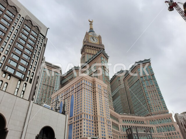 Clock tower hotels overlooking the Haram in Makkah Al-Mukarramah, Saudi Arabia, performing the rituals of Hajj and Umrah, worship and drawing closer to God, Islamic religious landmarks, luxury hotels, architectural art, the Sacred Mosque Square, the Holy 