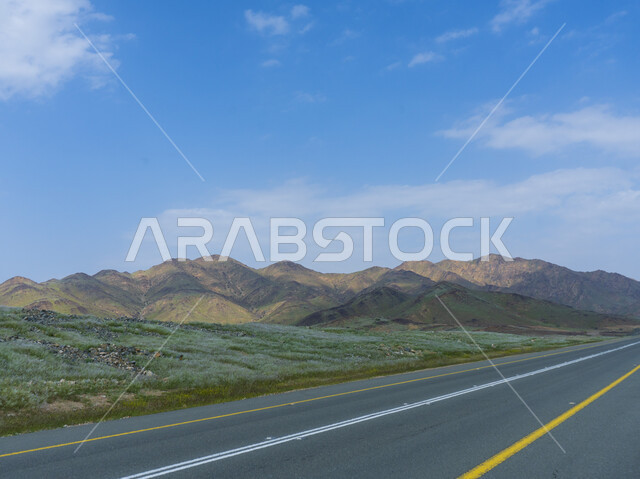 A road dedicated to crossing between plateaus and mountains covered with green plants, road righteousness, a beautiful mountain reserve in the day, the background of nature.