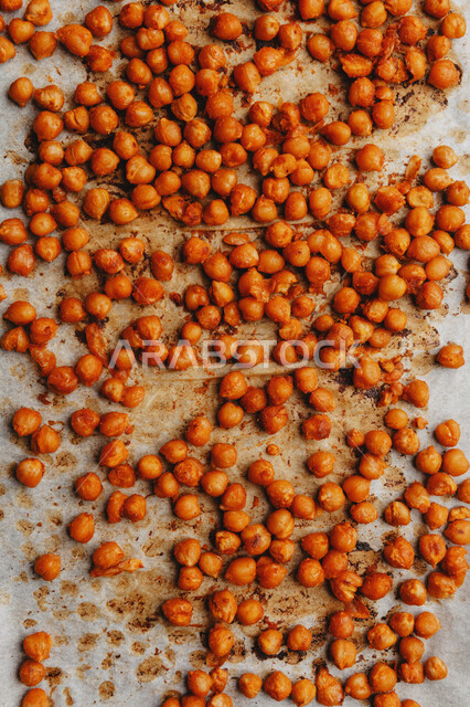 Close-up of spiced chickpeas, legumes, grains and seeds, background of fresh chickpeas