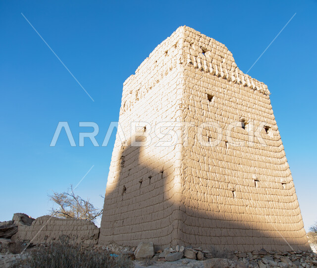 A wall of an old house made of mud in the Asir region in Ahad Rufaidah, archaeological historical places in the Kingdom of Saudi Arabia, old buildings, old historical houses.