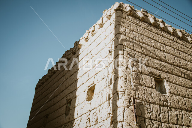 A wall of an old house made of mud in the Asir region in Ahad Rufaidah, archaeological historical places in the Kingdom of Saudi Arabia, old buildings, old historical houses.