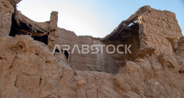 A wall of an old house made of mud abandoned and not restored in the Asir region in Ahad Rufaidah, historical and archaeological places in the Kingdom of Saudi Arabia, old buildings, old historical houses.