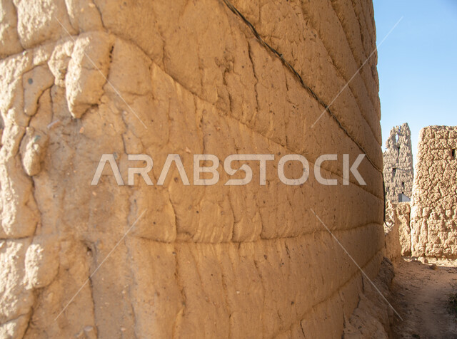 A wall of an old house made of clay and stacked stones in the Asir ...