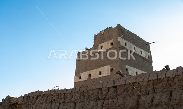 Windows of a restored heritage house made of clay and stacked stones in the Asir region in Ahad Rufaidah, historical archaeological sites in the Kingdom of Saudi Arabia, old buildings, old historical houses.