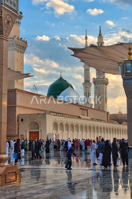 The courtyard of the Prophet’s Mosque in Medina, Saudi Arabia, worship and getting closer to God, the Prophet’s Mosque, holy Islamic places, Muslims walking in the outer complex of the Prophet’s Mosque in Medina, electronic umbrellas